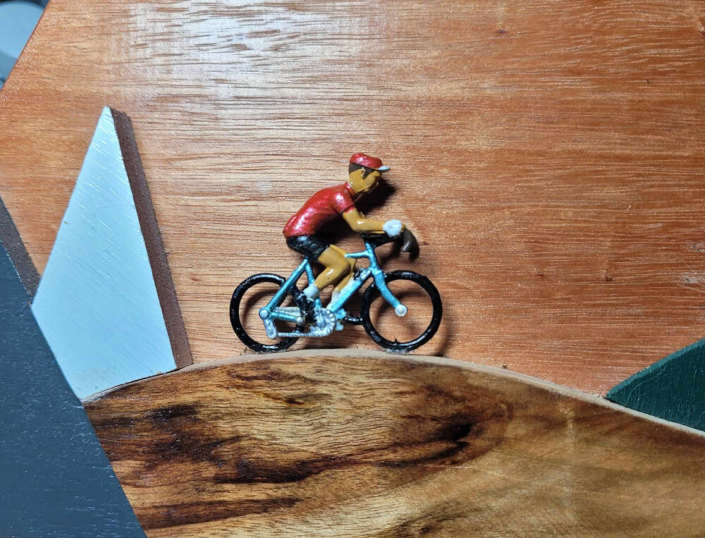Retro vintage cyclist riding through a stylised mountain scene