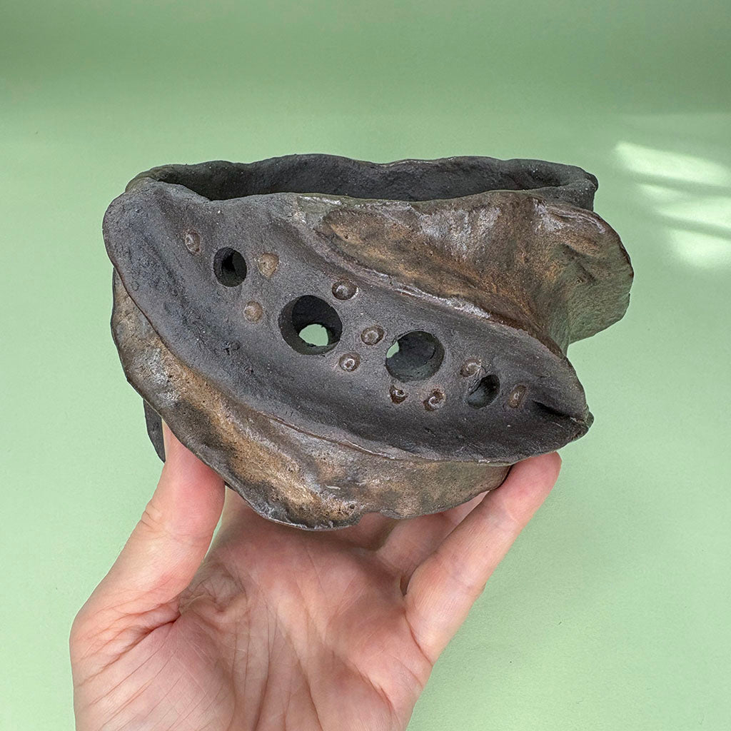 Ceramic orchid pot with twisting ridges