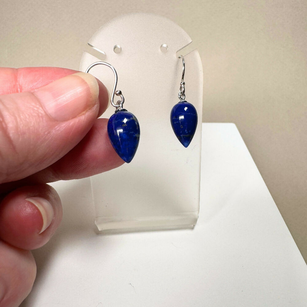 Lapis lazuli earrings held by hand