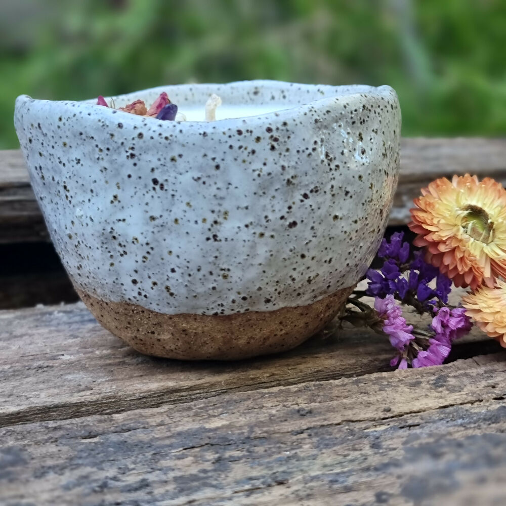 Soy candle in a speckled pottery bowl with matte white glaze