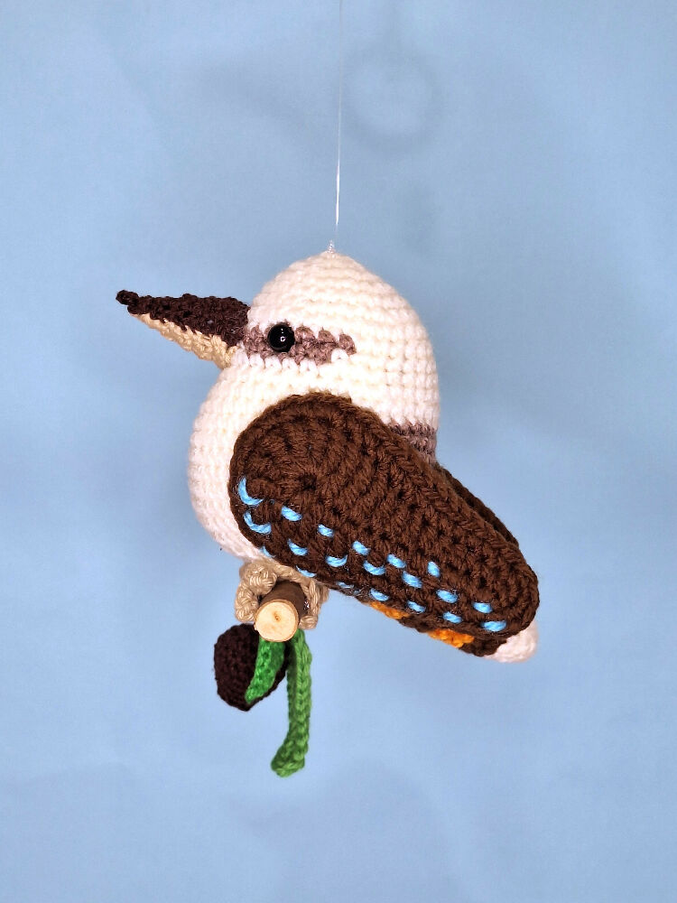 Crocheted laughing Kookaburra room decoration on perch