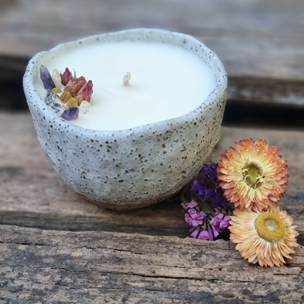 Soy candle in a speckled pottery bowl with matte white glaze