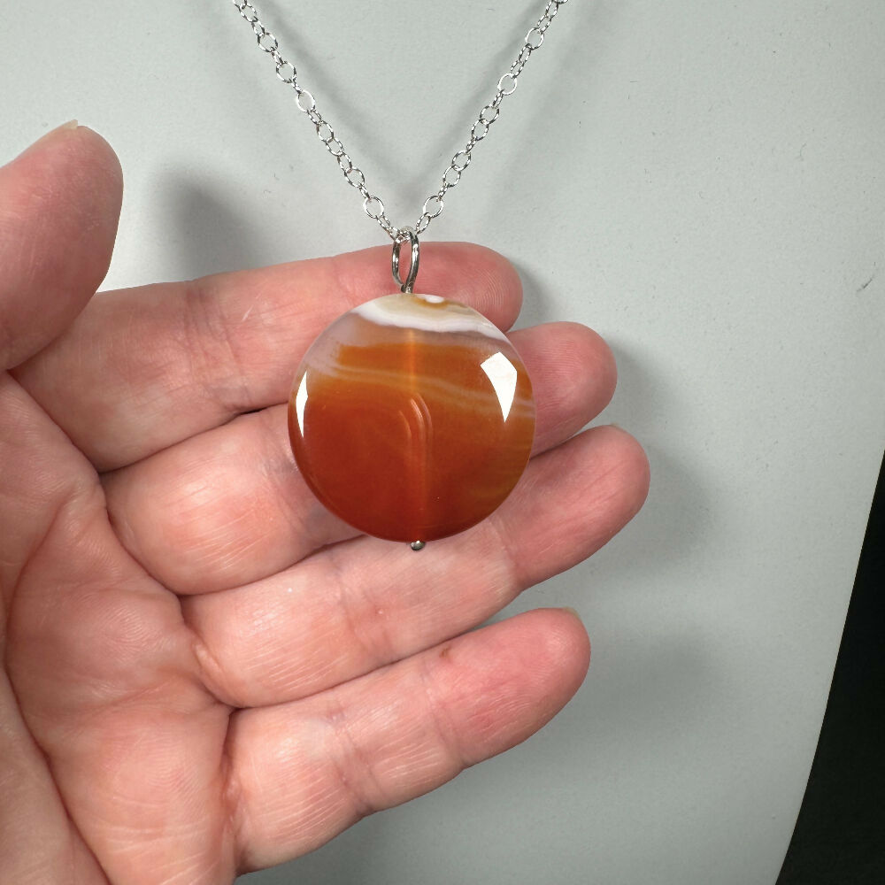 Carnelian necklace close up on hand