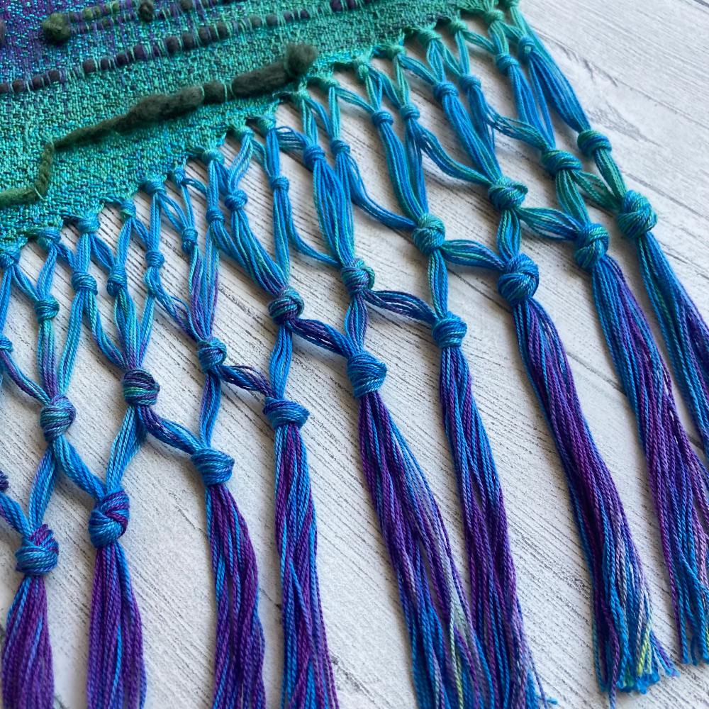 handwoven-wall-hanging-rainbow-entangled-happiness-handwovens-closeup-fringe-blue-purple