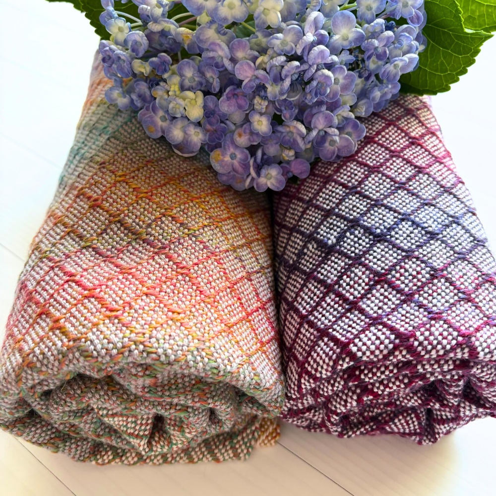 Closeup-rolled-with-flower-handwoven-baby-blanket-entangledhappinesshandwoven-purple