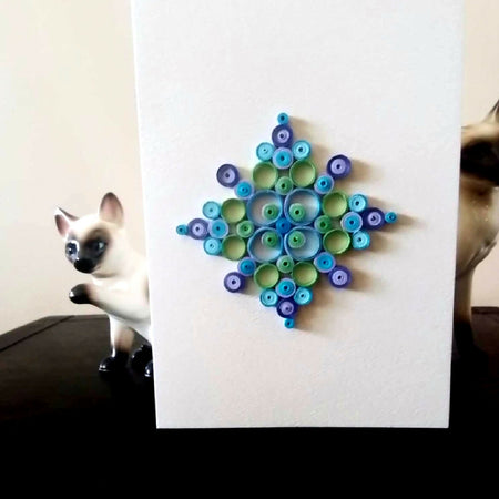 Handmade mandala quilled greeting card in purple, blue and green