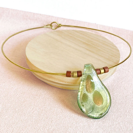 Green lampwork pendant on beaded brass necklace