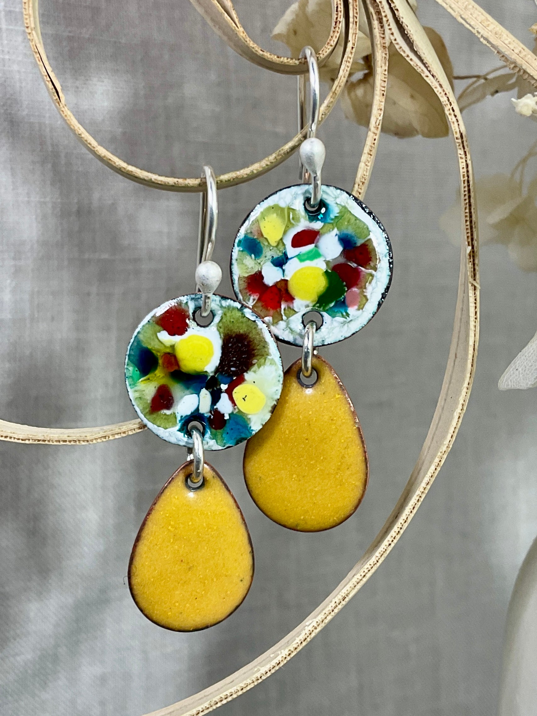 Mustard tear drop with abstract disc. Enamel. Handmade