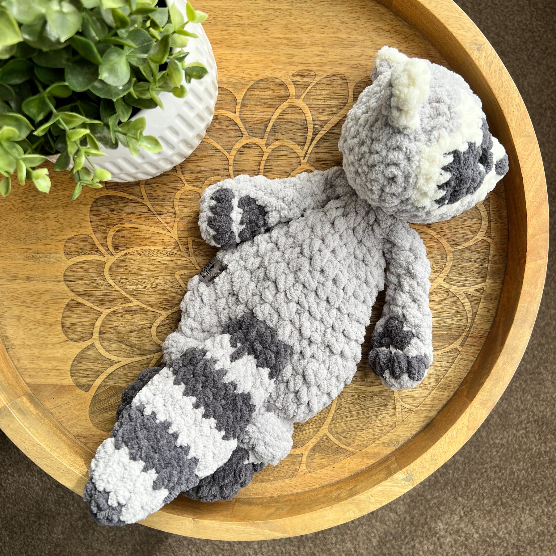 Handmade crochet modern Raccoon lovey snuggler with knotted legs.