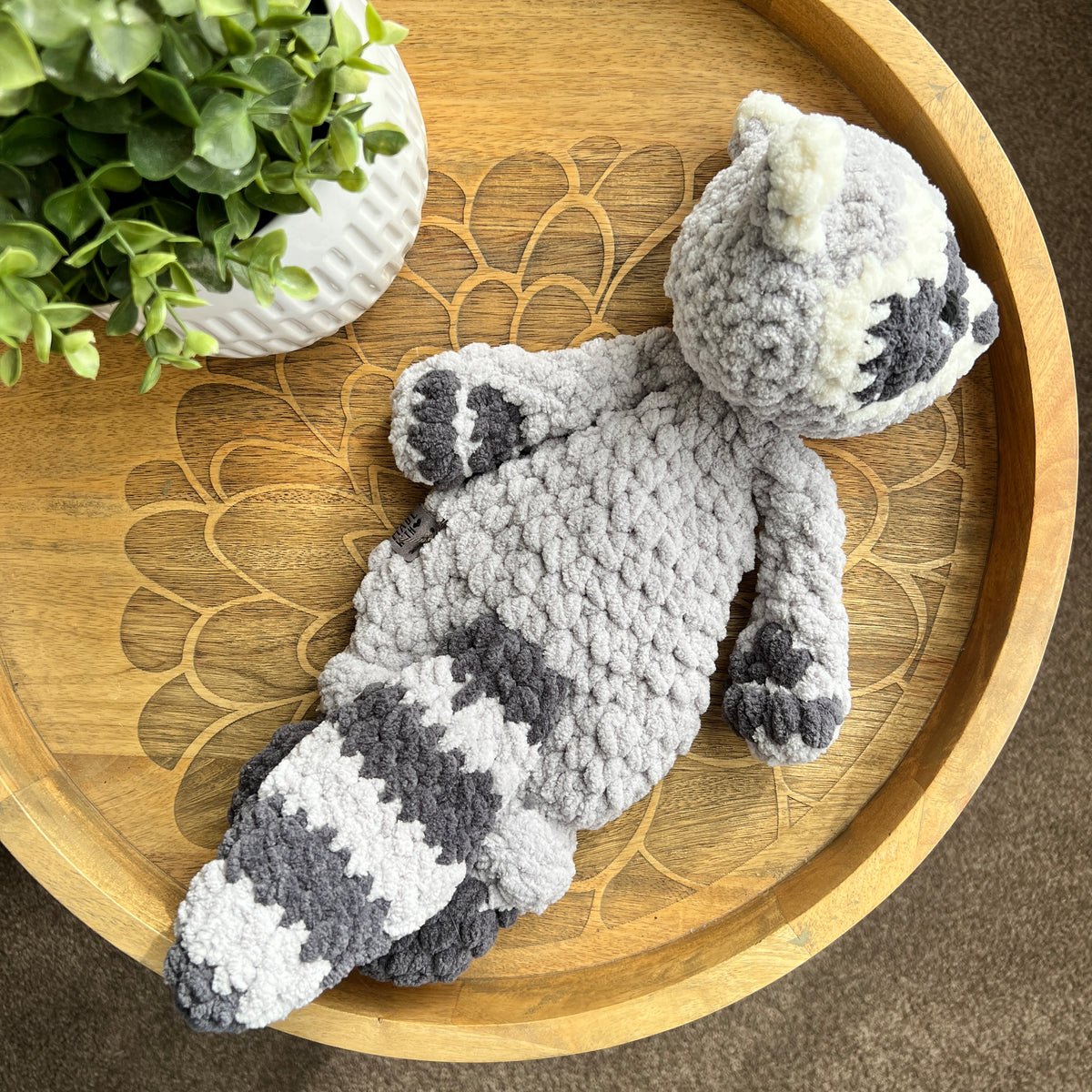 Handmade crochet modern Raccoon lovey snuggler with knotted legs.