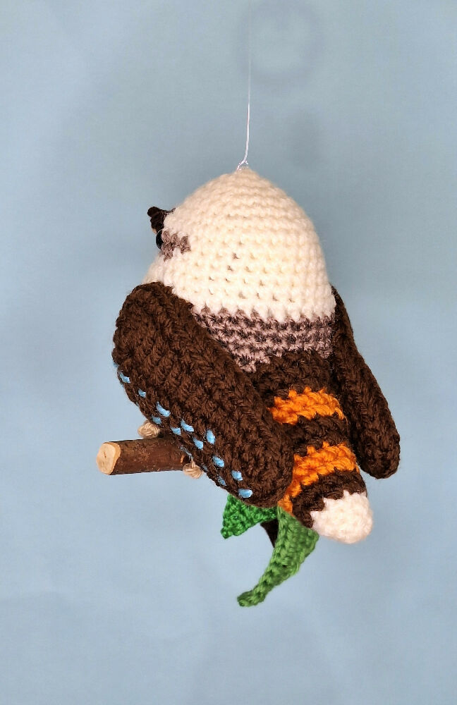 Crocheted laughing Kookaburra room decoration on perch