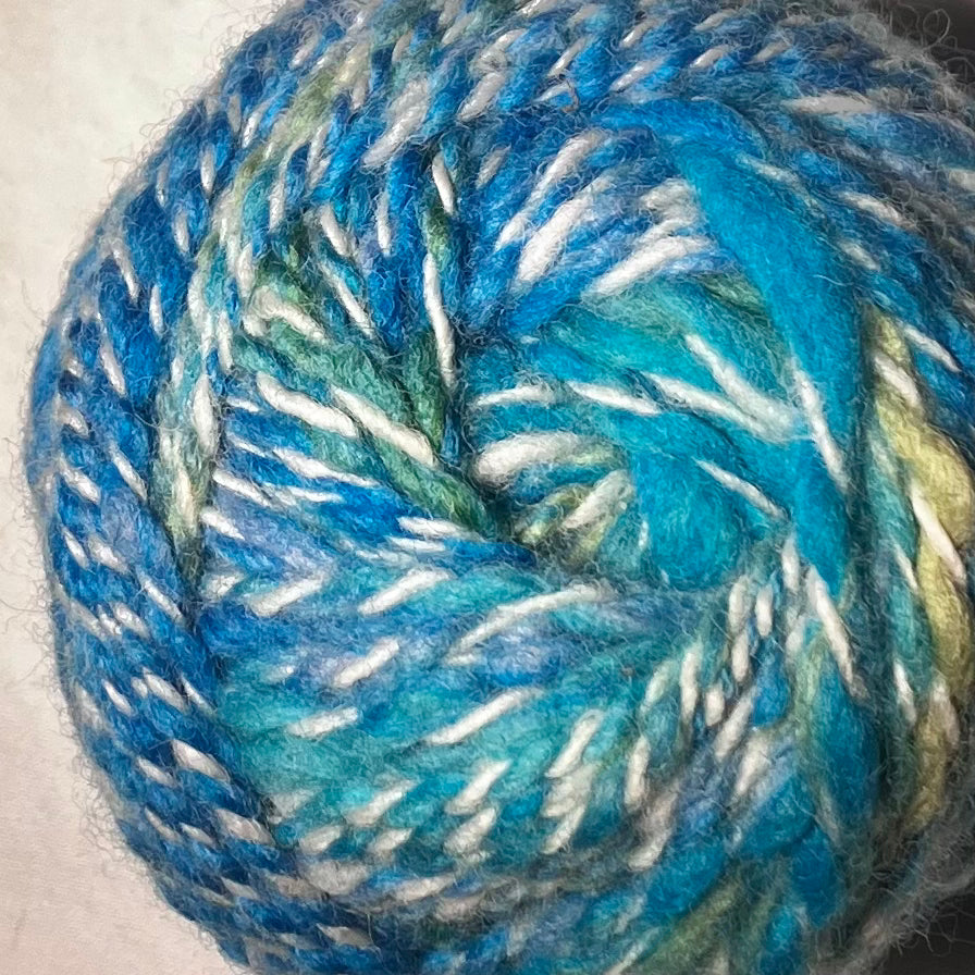 Wool cake in blues and greens