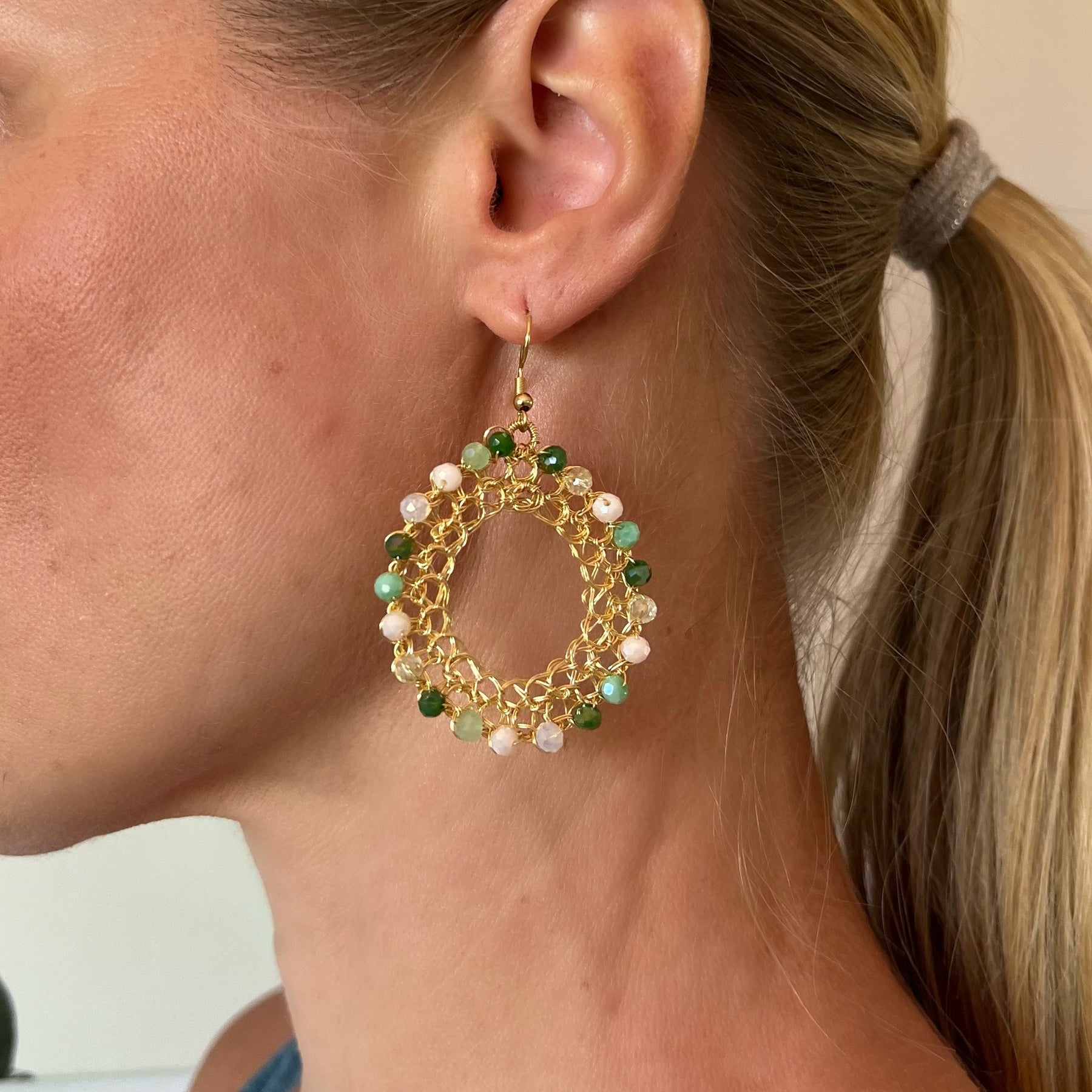 Gold wire hoop earrings, green crystals