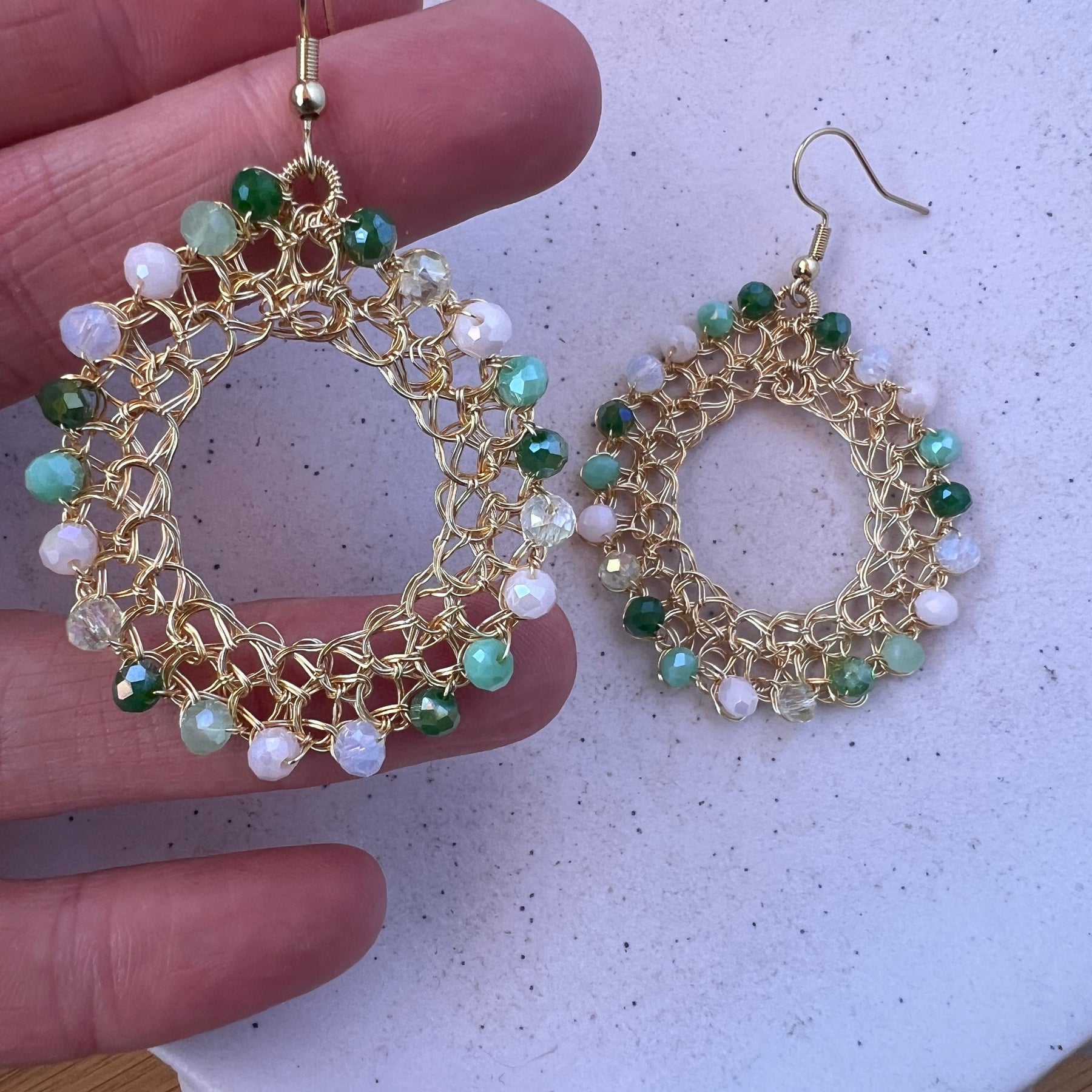 Gold wire hoop earrings, green crystals
