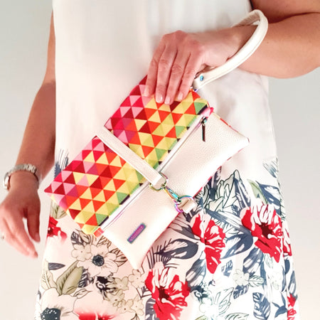 Modern, stylish white leatherette fold over zipper clutch with detachable strap