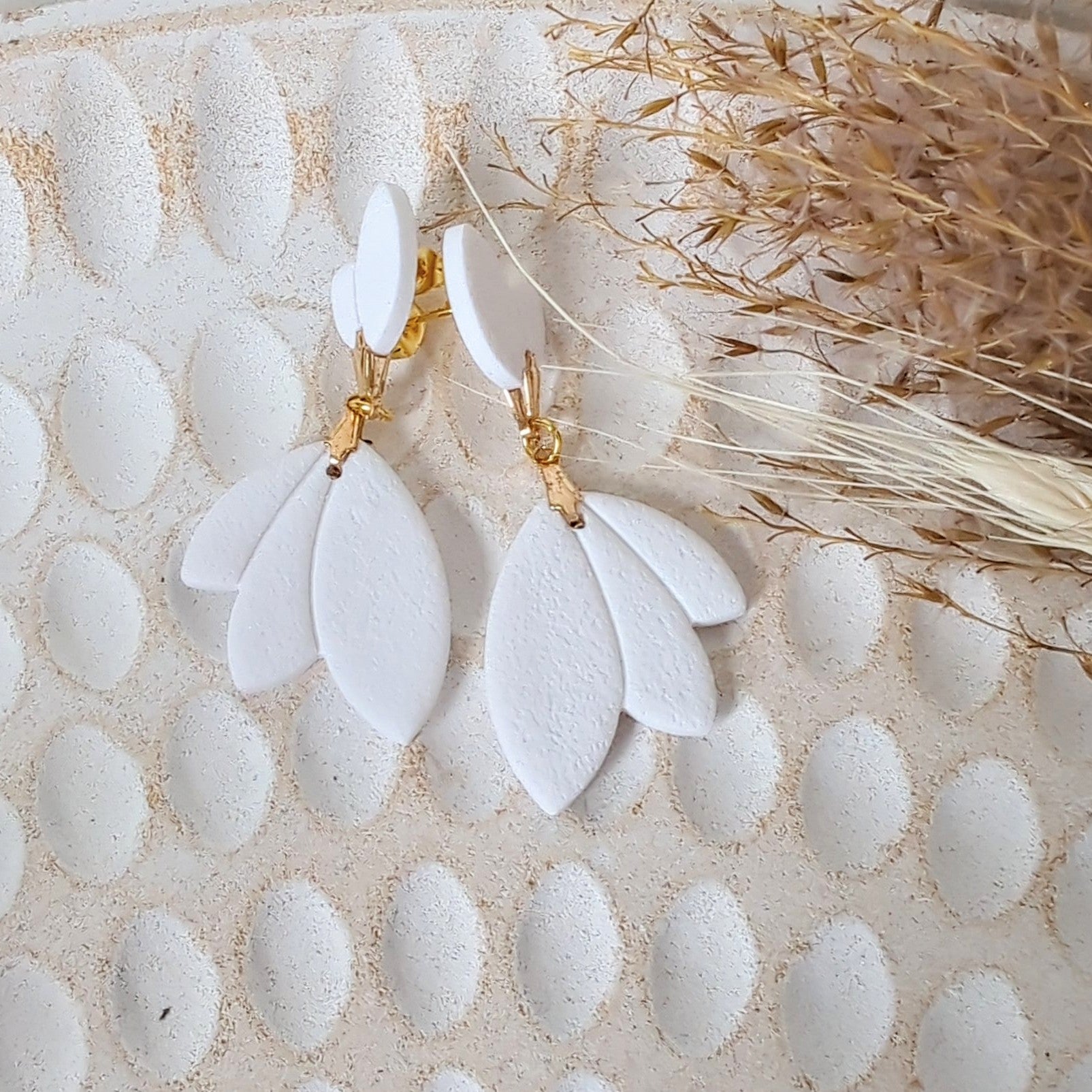 White Earrings With Gold Findings in Different Designs.