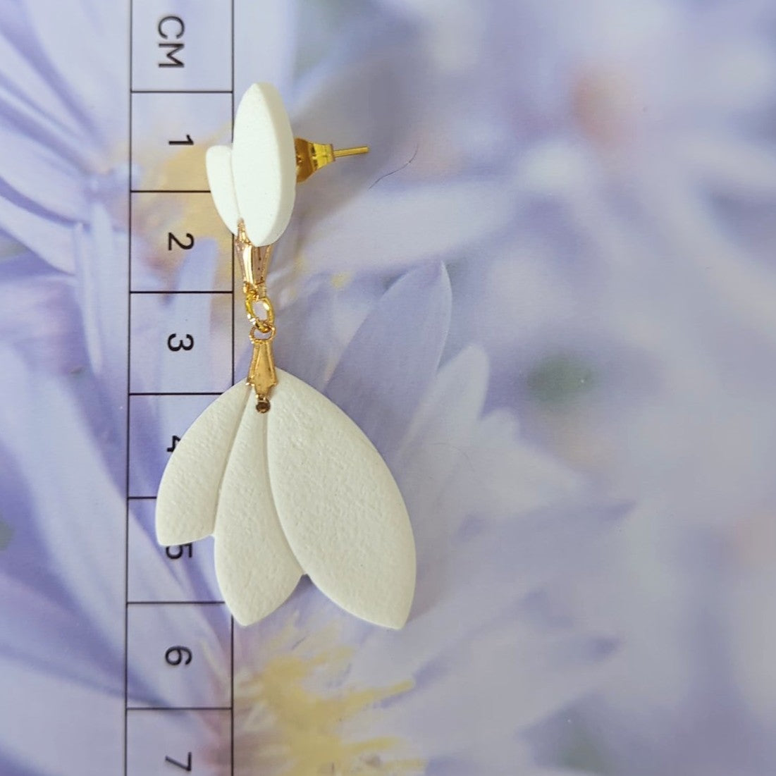White Earrings With Gold Findings in Different Designs.