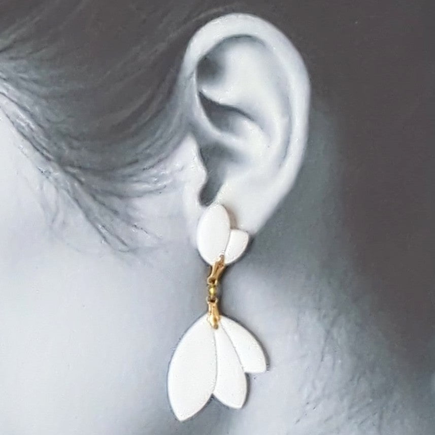 White Earrings With Gold Findings in Different Designs.