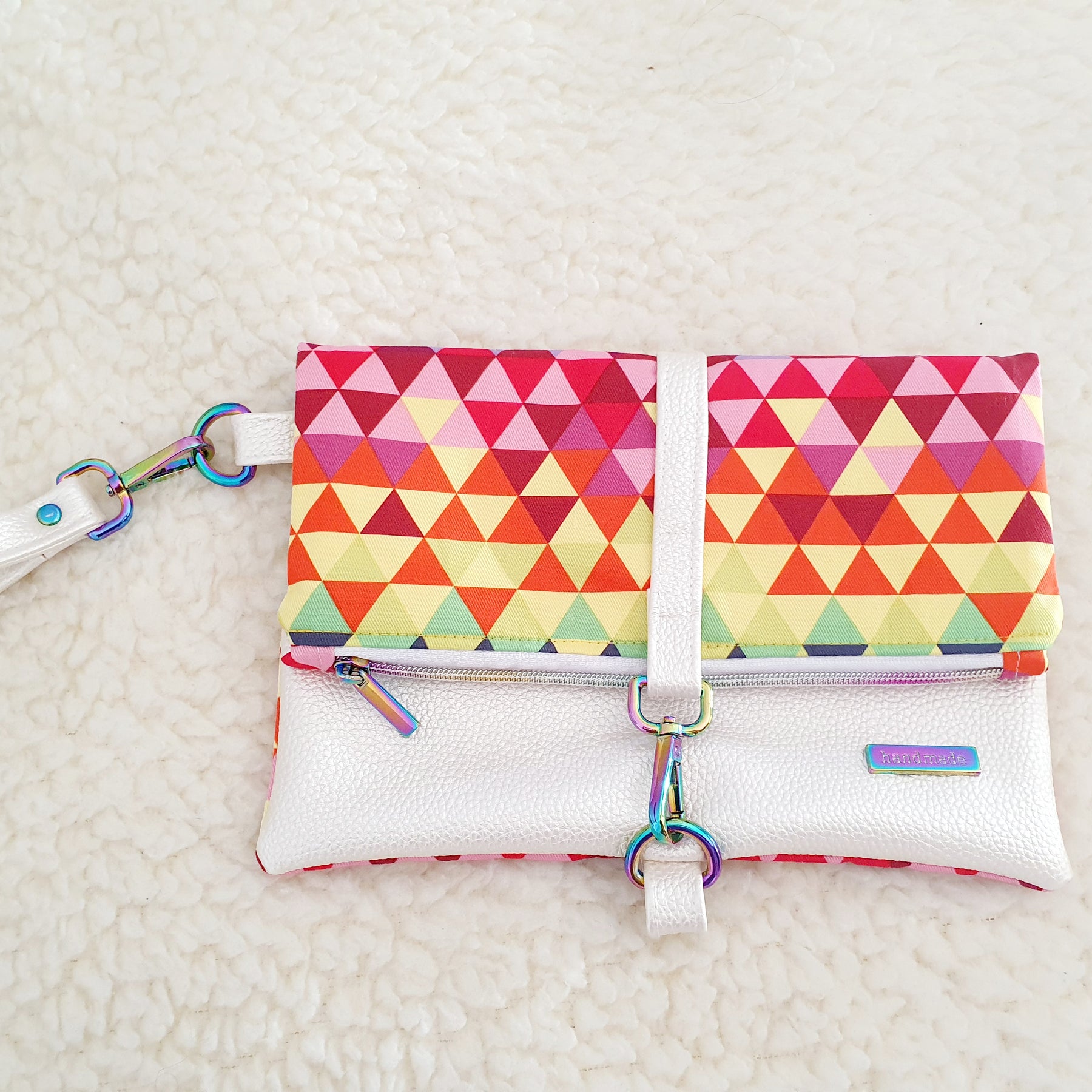 Modern, stylish white leatherette fold over zipper clutch with detachable strap