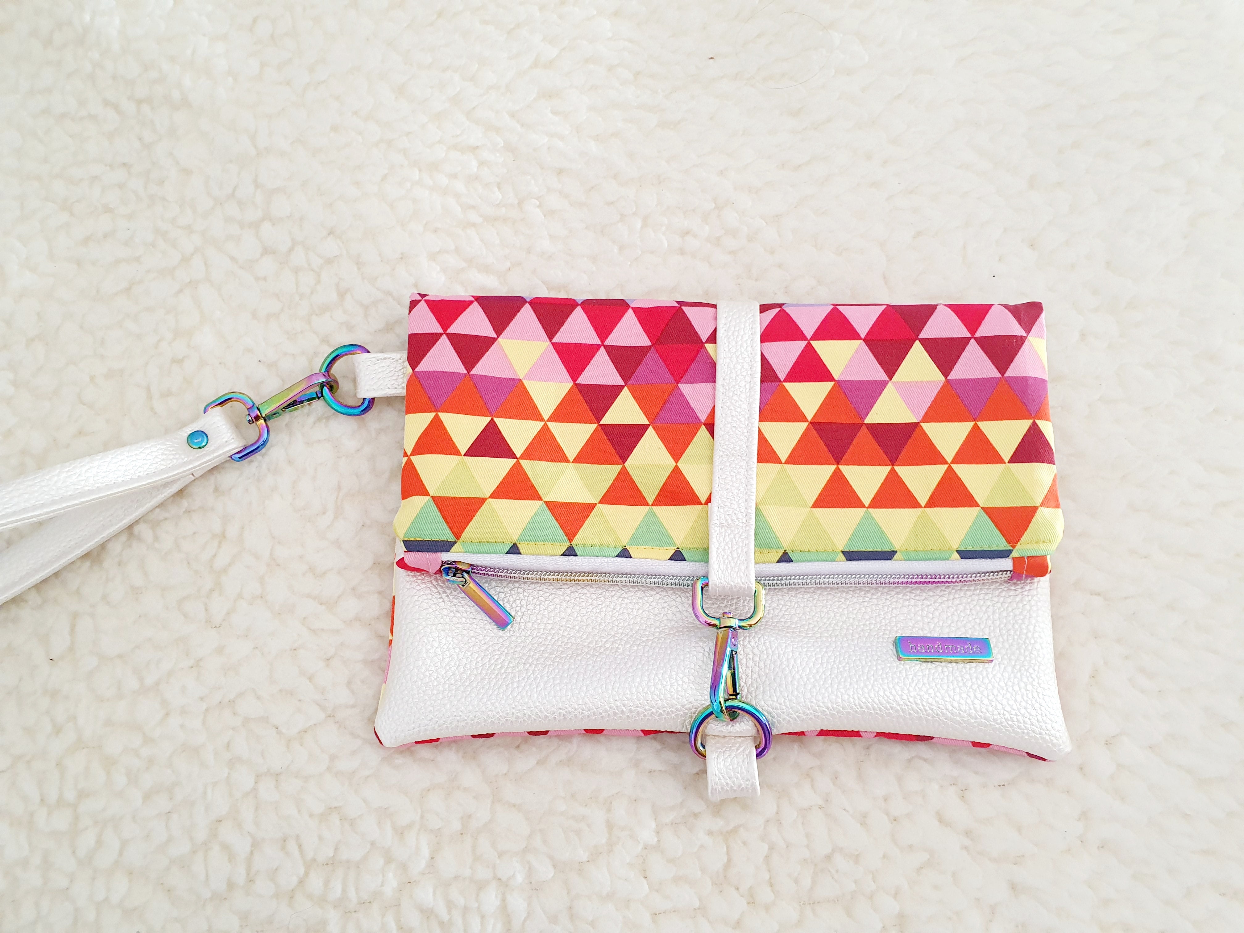 Modern, stylish white leatherette fold over zipper clutch with detachable strap