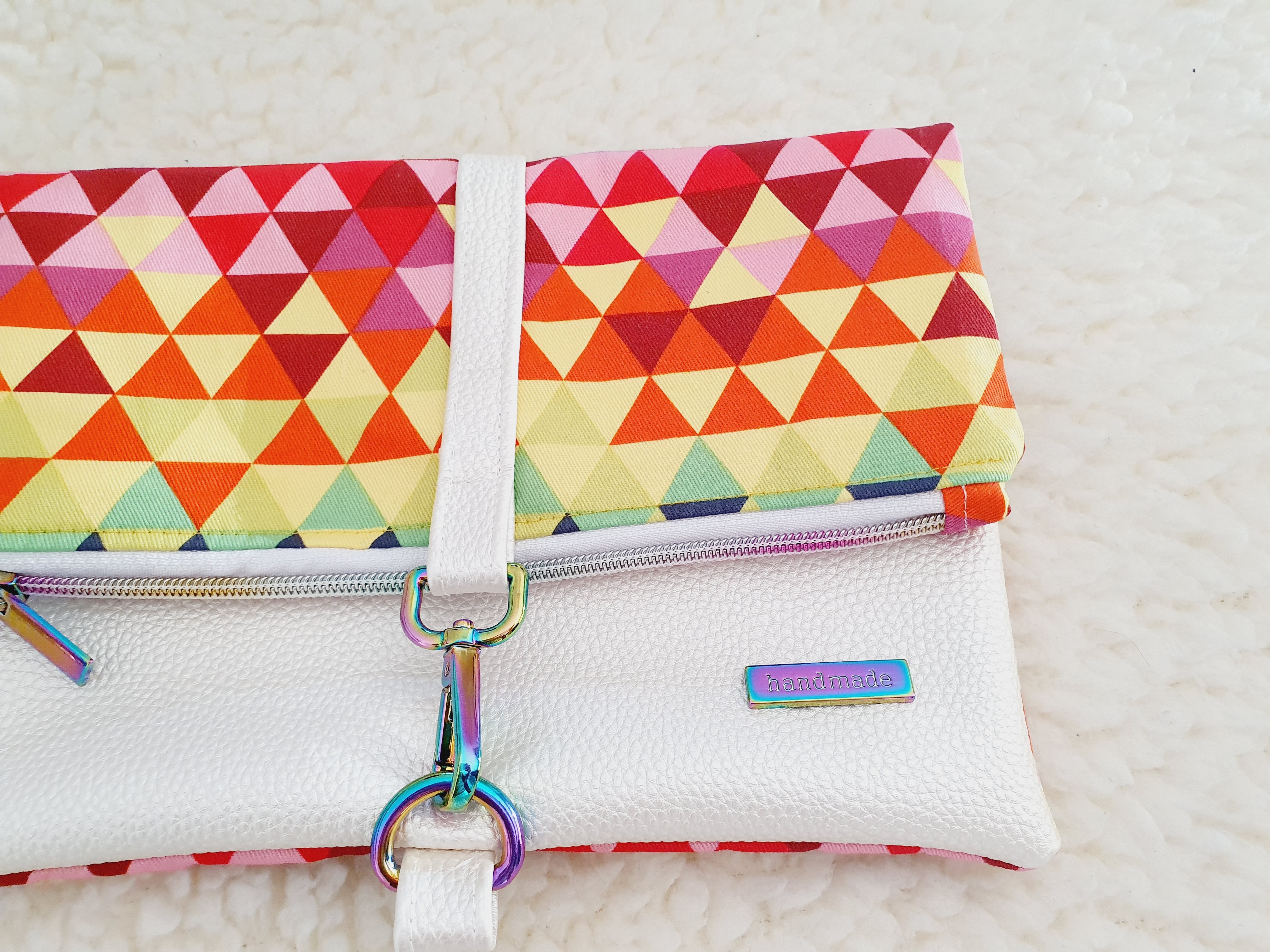 Modern, stylish white leatherette fold over zipper clutch with detachable strap