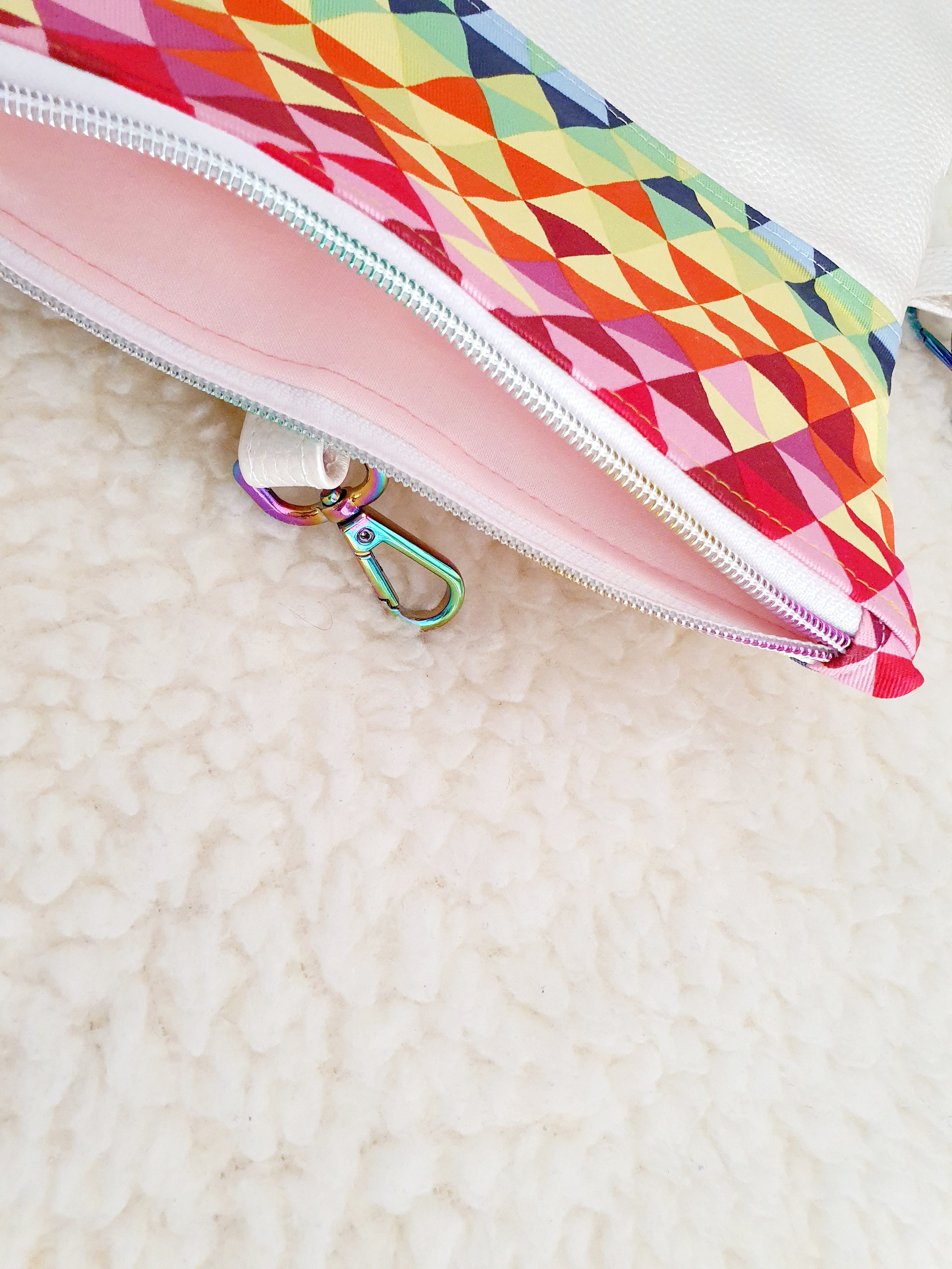 Modern, stylish white leatherette fold over zipper clutch with detachable strap