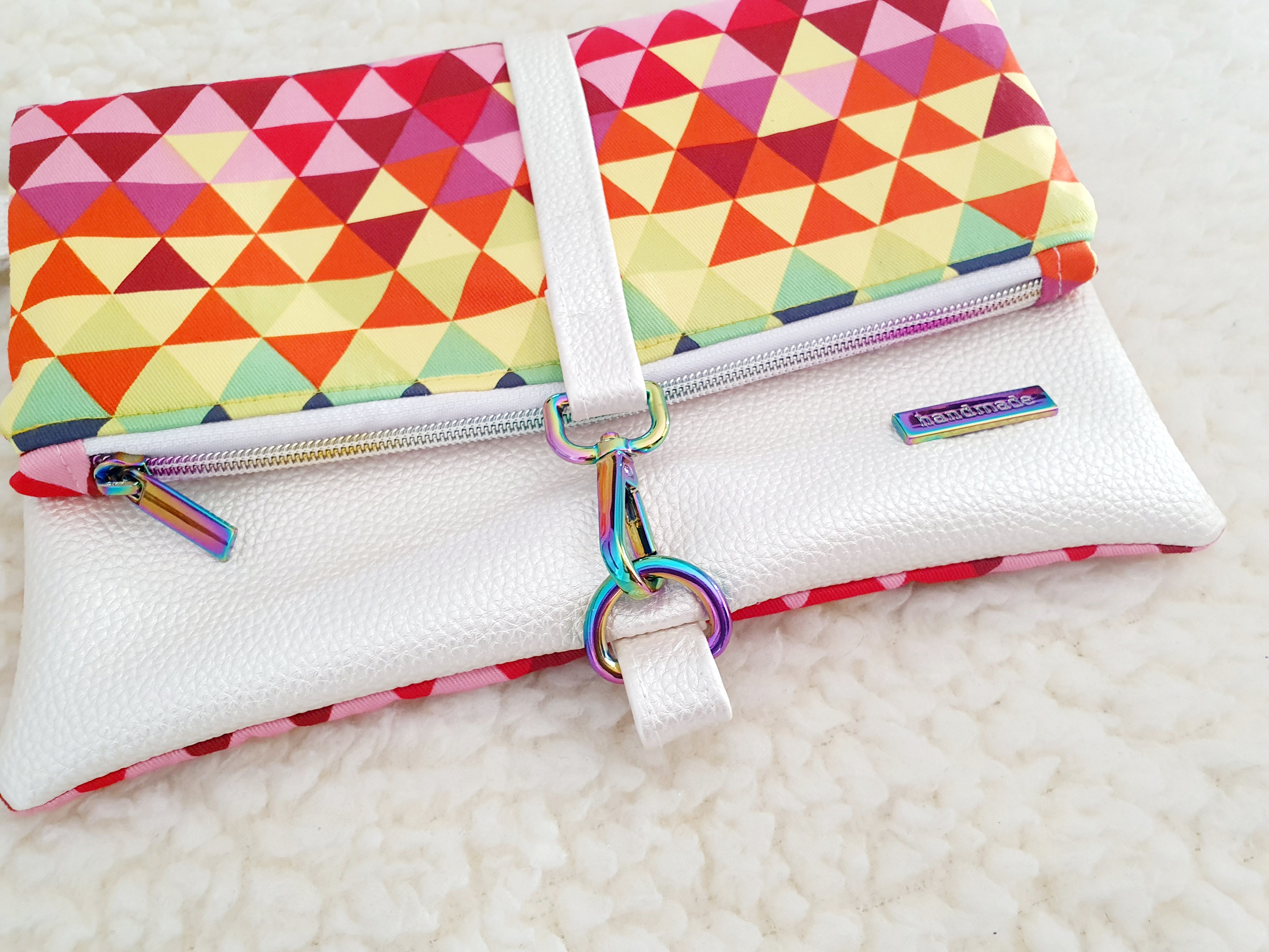 Modern, stylish white leatherette fold over zipper clutch with detachable strap