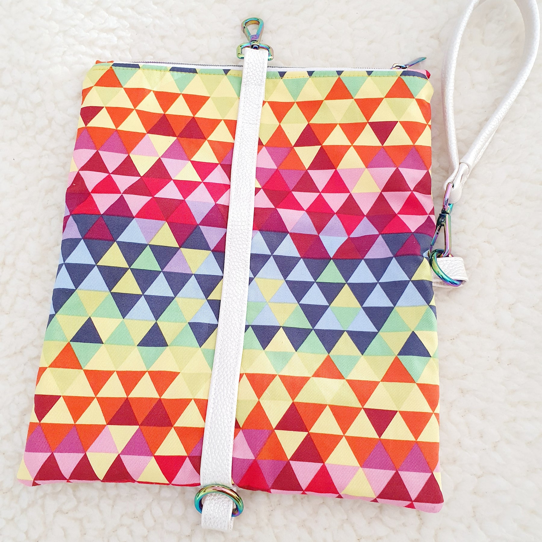 Modern, stylish white leatherette fold over zipper clutch with detachable strap