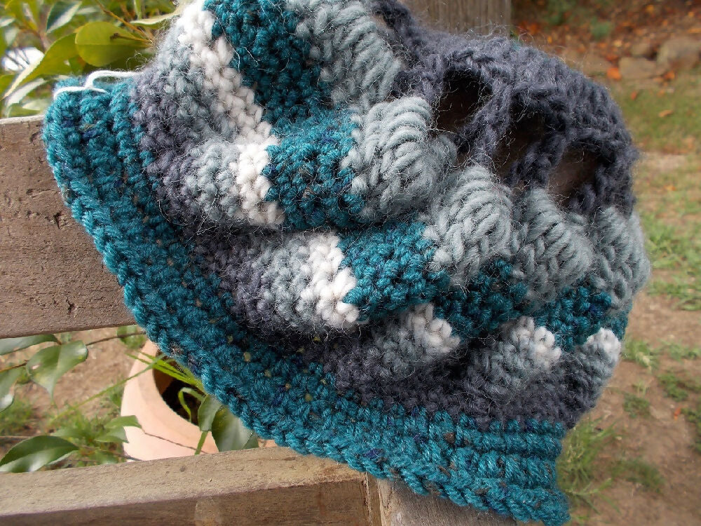 Crocheted winter hat in teal, grey and white wool