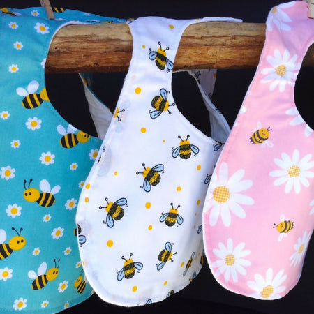 Set of three baby bibs, daisy and bee design.
