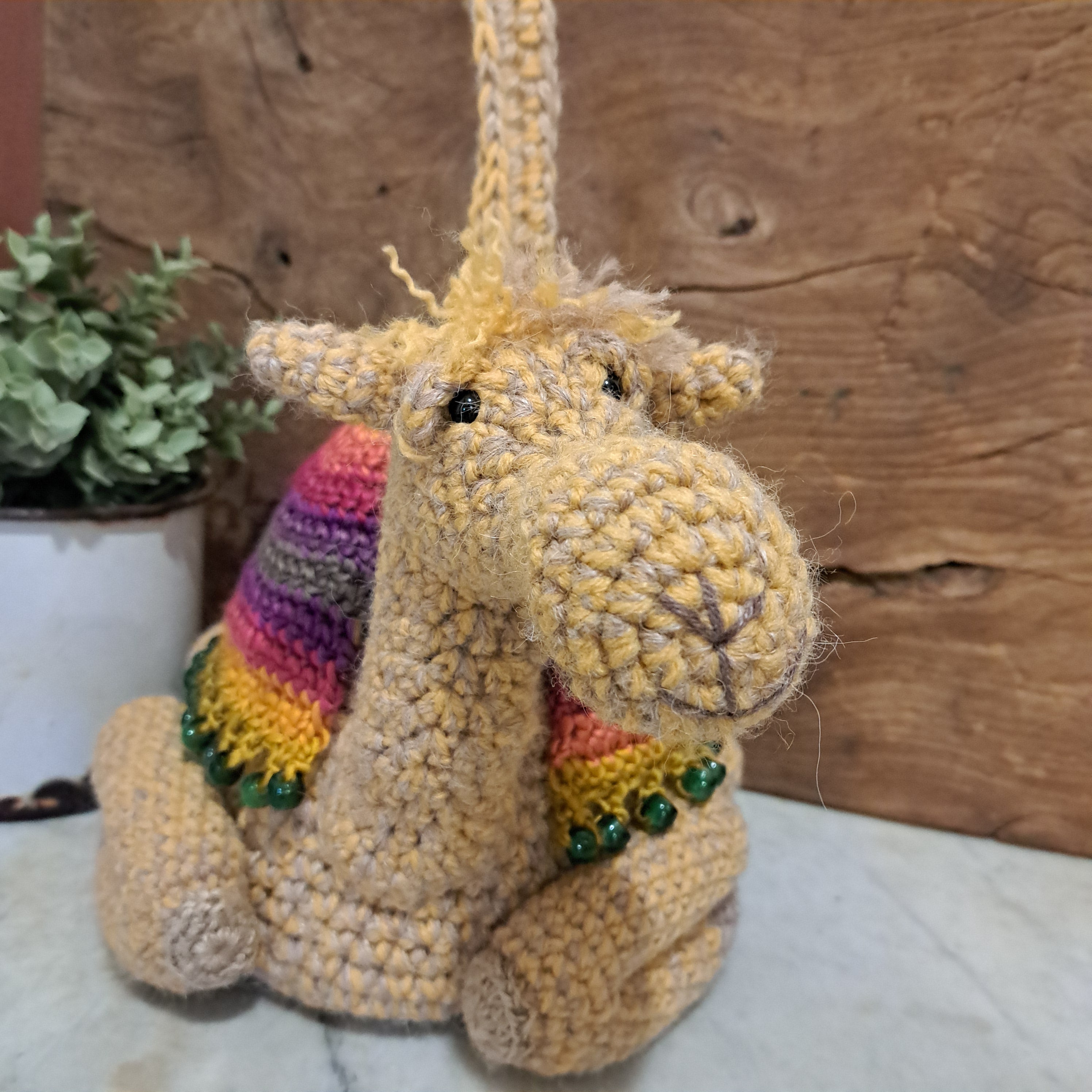 Handmade crochet camel doorstop colourful coat mustard coloured base