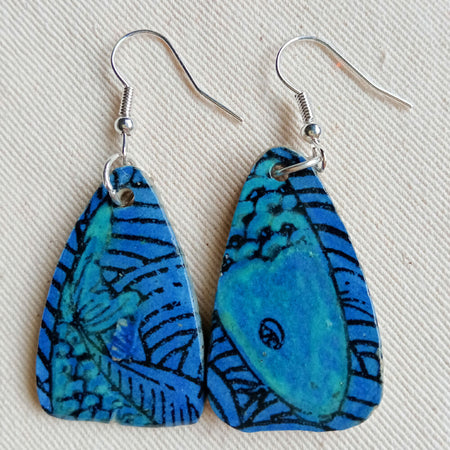 Azure blue ceramic teardrop shaped earrings with hints of teal and fish design