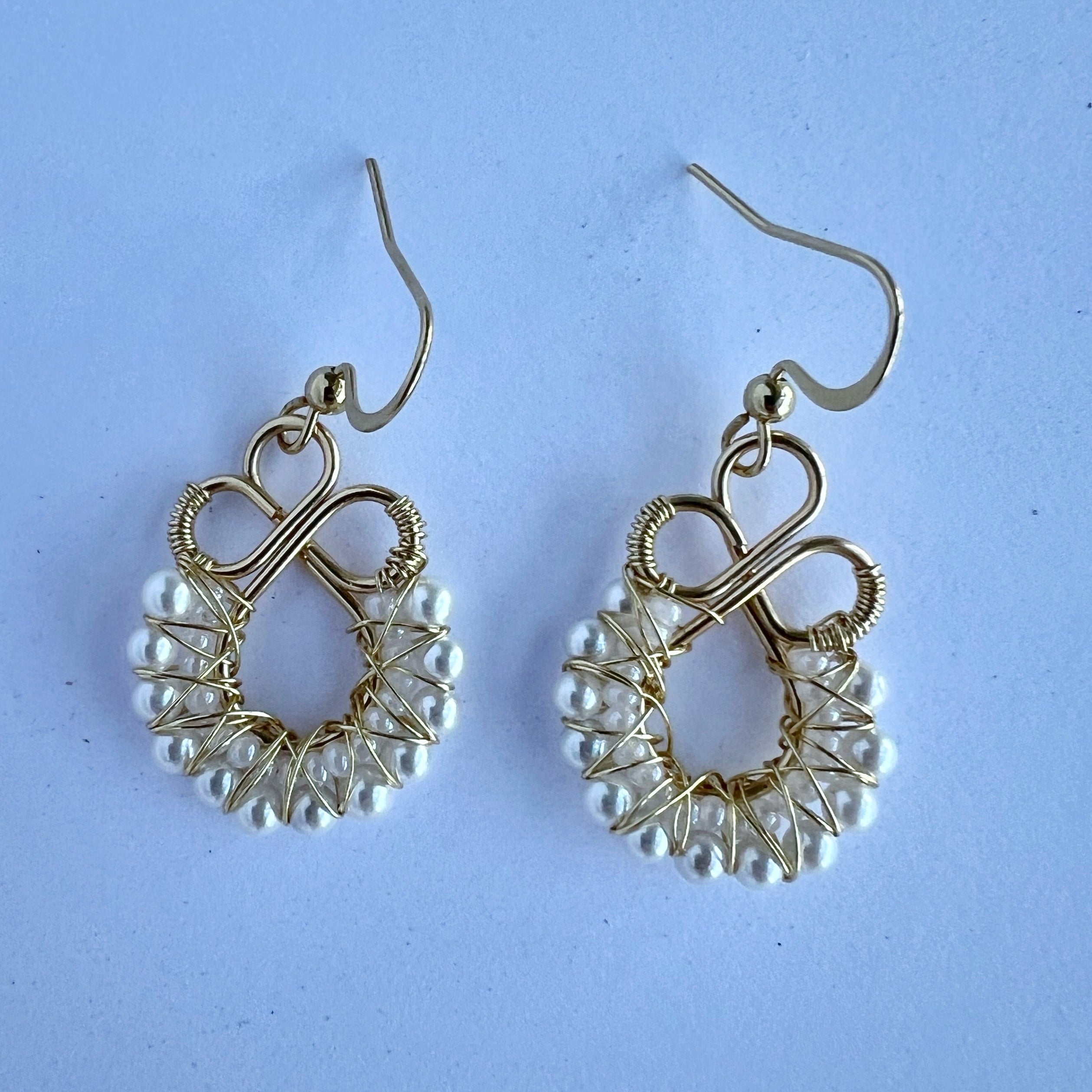Gold wire wrapped earrings with shell based peals and Czech seee beads