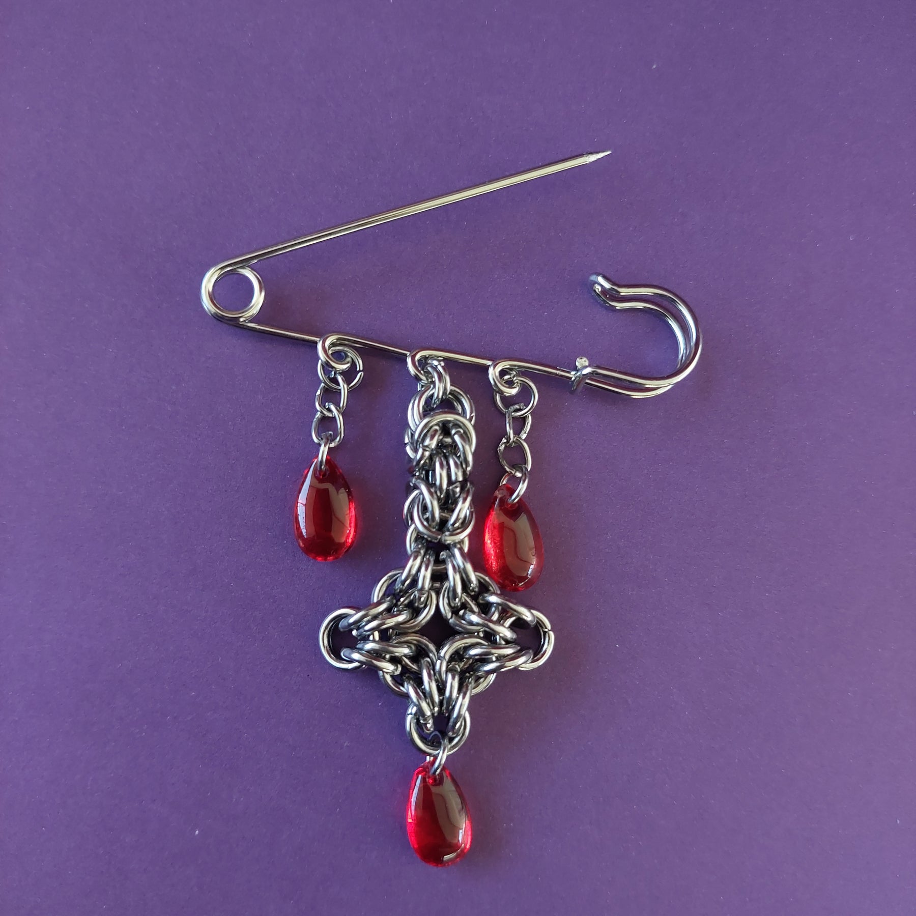 Bleeding cross brooch