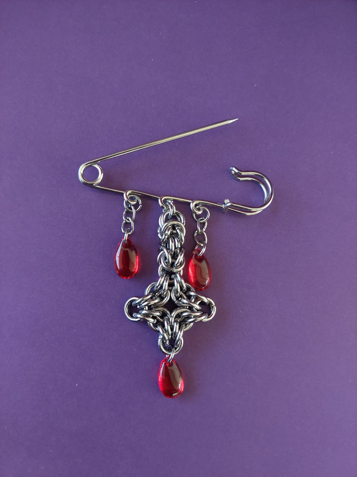 Bleeding cross brooch