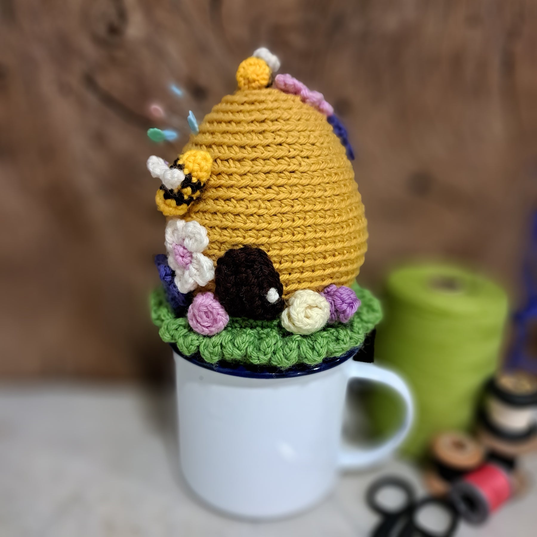 Crochet beehive pin cushion in a sturdy enamel tin mug