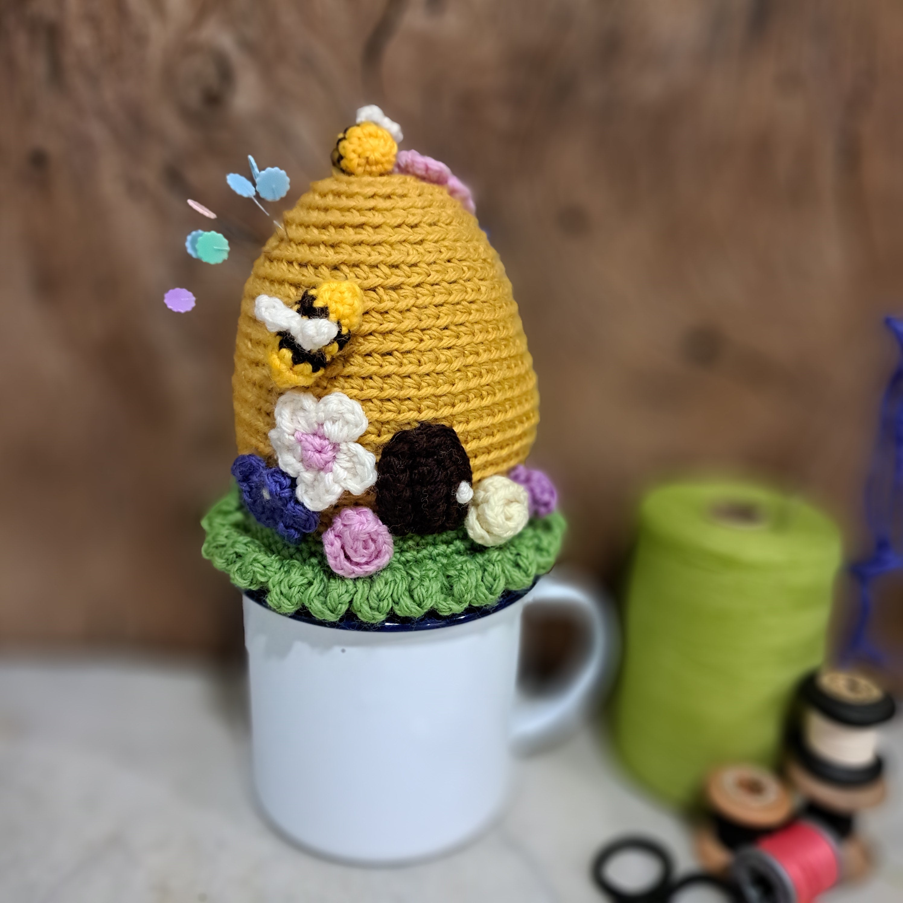 Crochet beehive pin cushion in a sturdy enamel tin mug