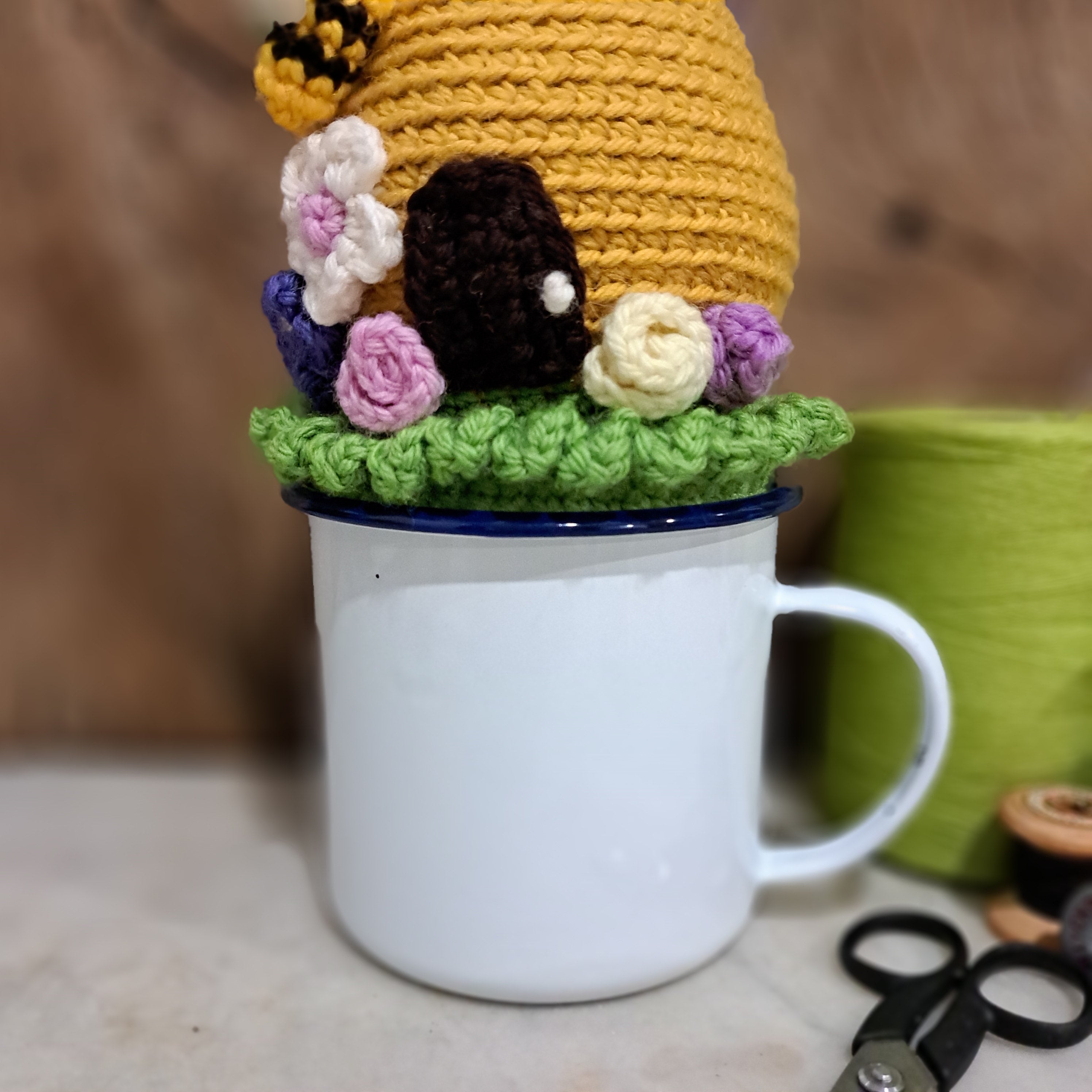 Crochet beehive pin cushion in a sturdy enamel tin mug