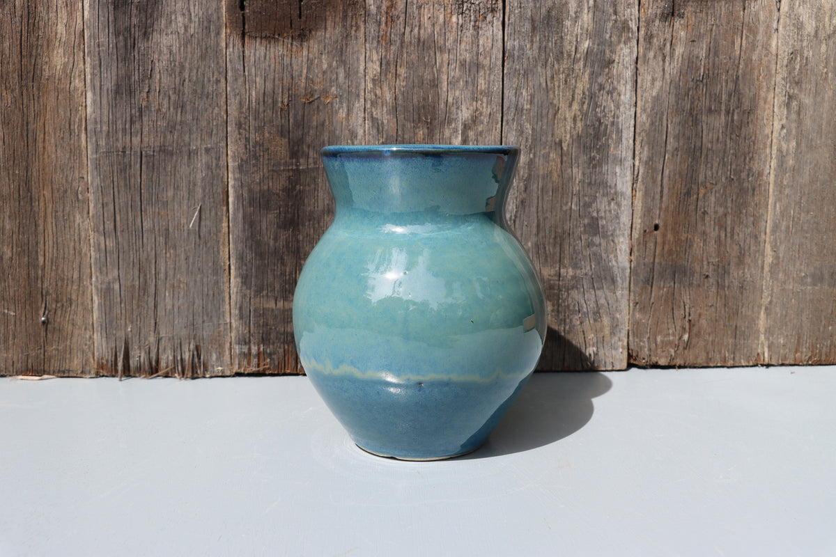 Large blue stoneware vase with blue green speckled glaze on buff clay
