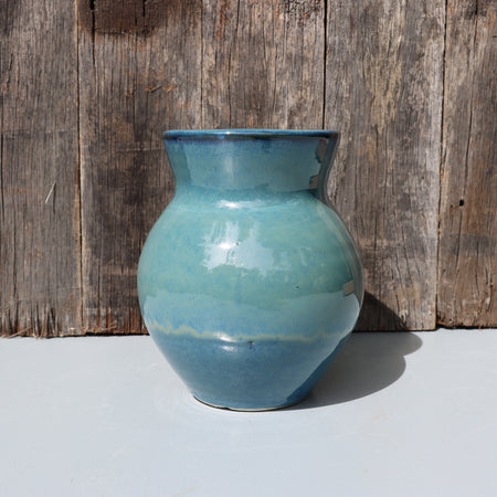 Large blue stoneware vase with blue green speckled glaze on buff clay