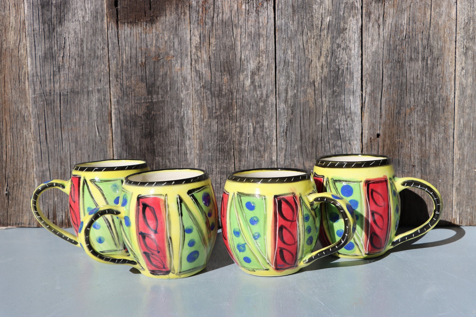 Hand-Painted Mug: Abstract yellow, red, green, black and blue mid-fire stoneware