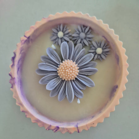 Round orange and purple concrete bowl candle with rose and lavender scent