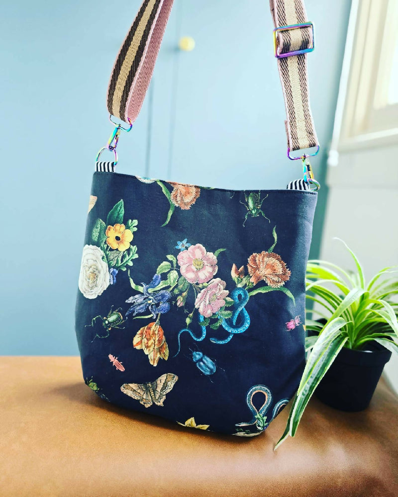 Large black crossbody bag. Snakes, bugs and flowers.