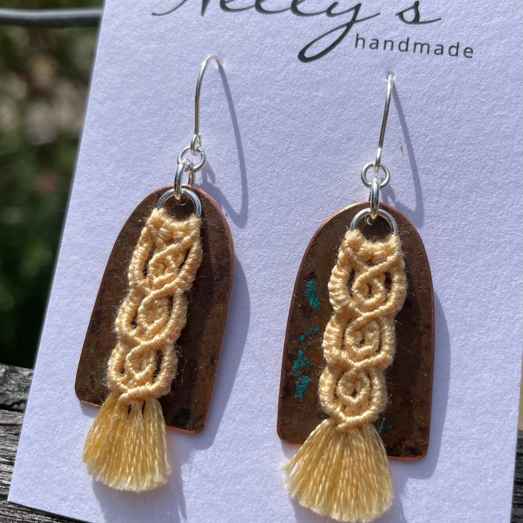 Yellow macrame thread on patinated copper