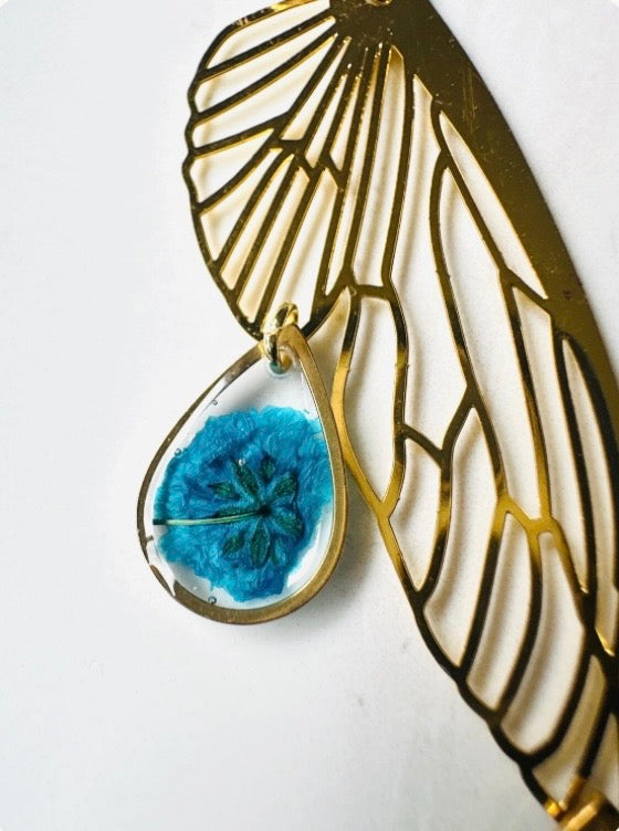 Butterfly resin earring with blue pressed flowers