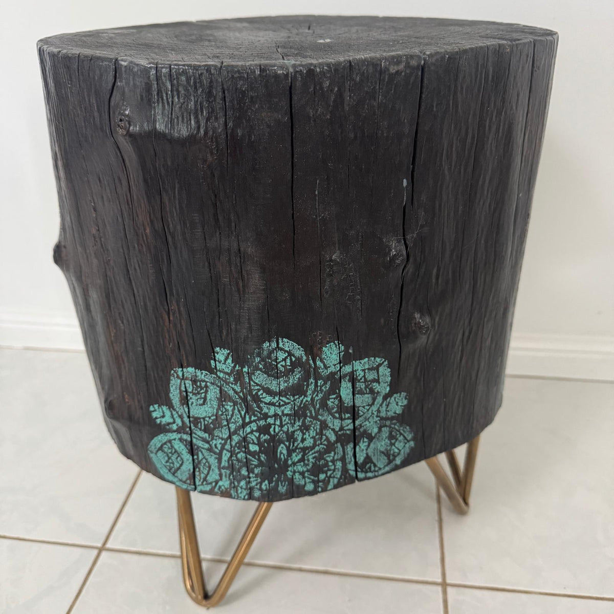 Timber stump table featuring teal mandala hand-painted artwork