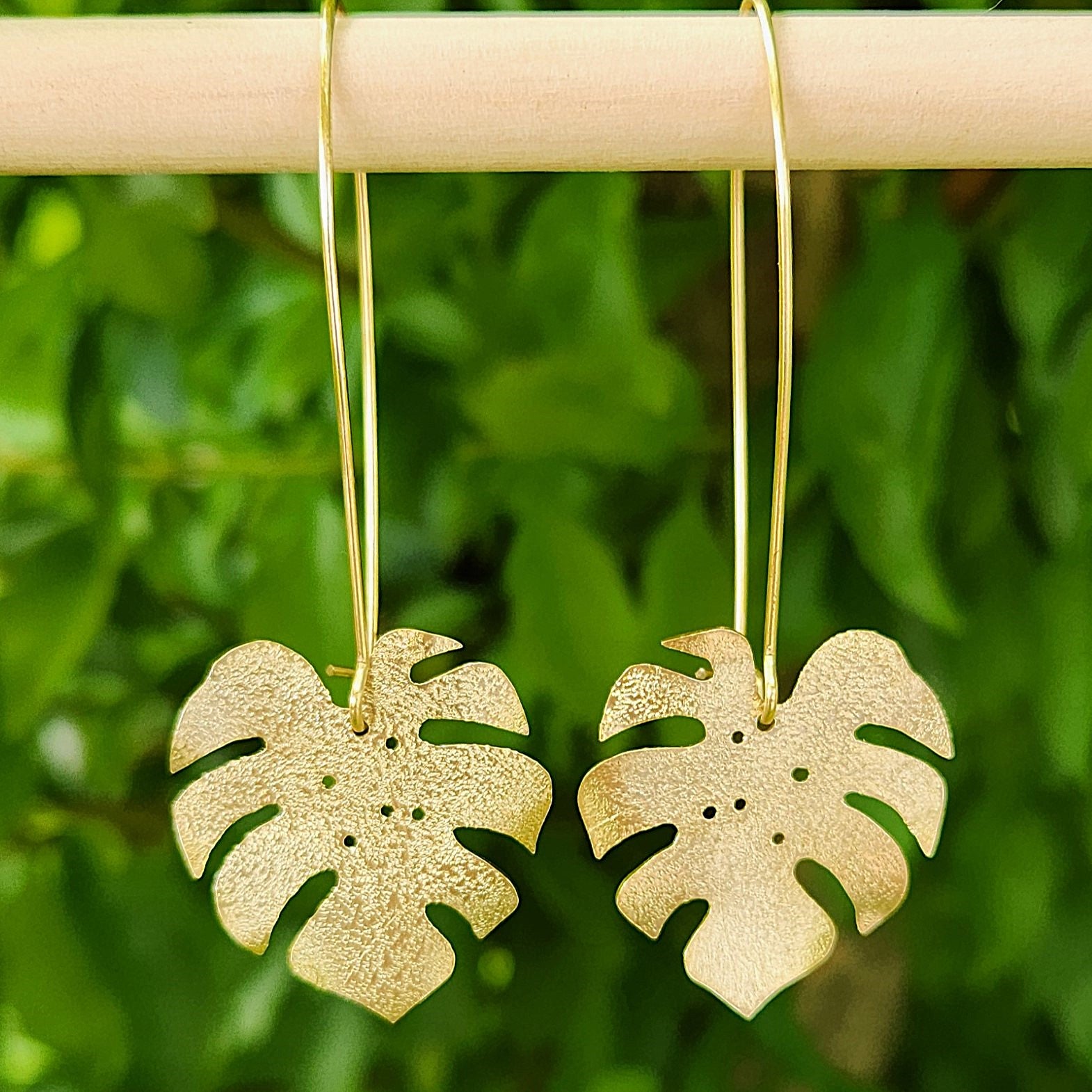 Golden tone monstera earrings