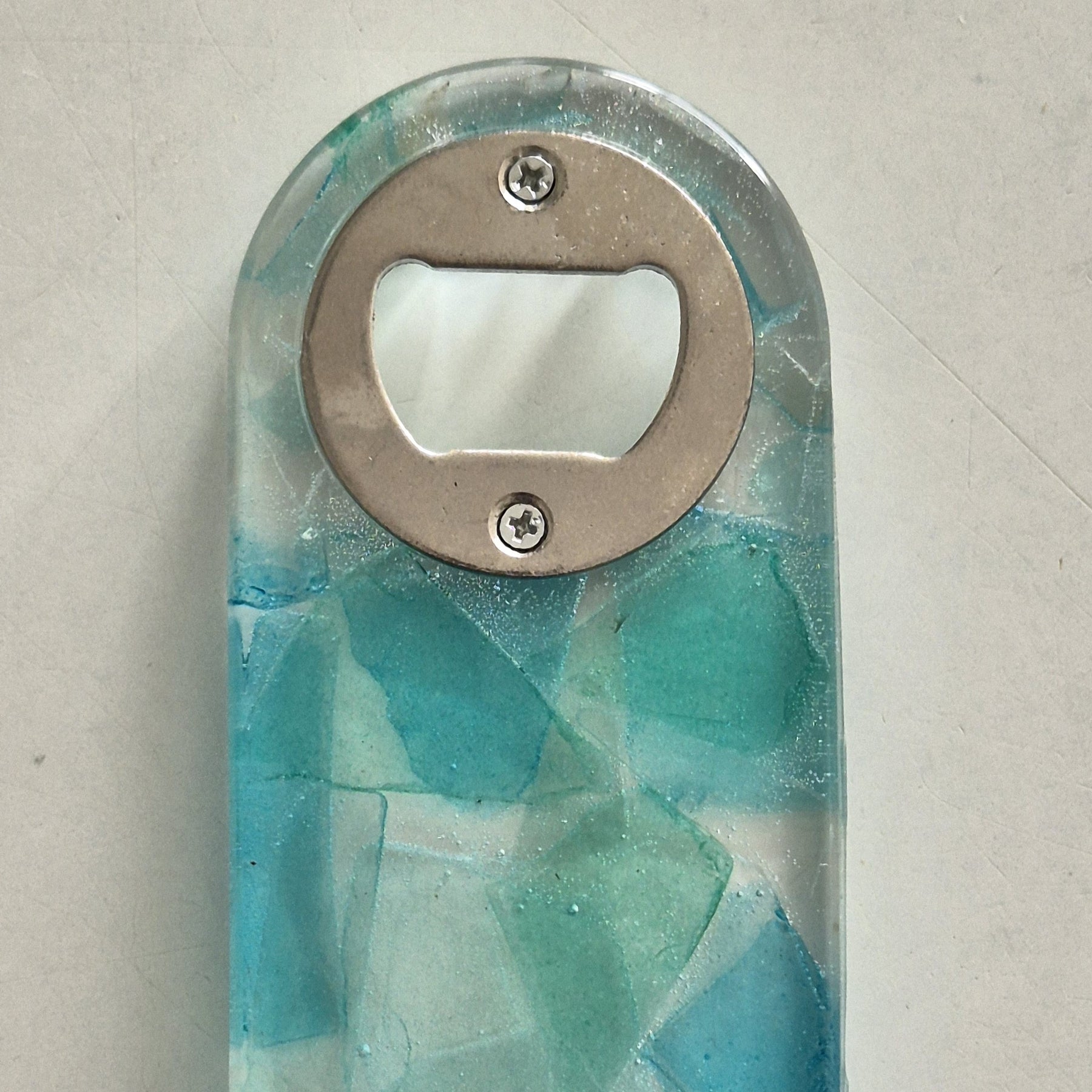 Resin bottle opener with inlaid sea glass