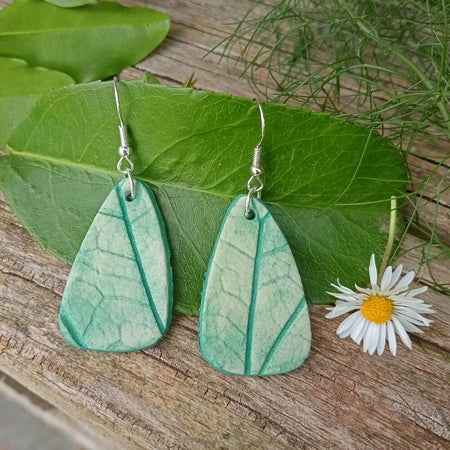 Green ceramic teardrop earrings with leaf prints