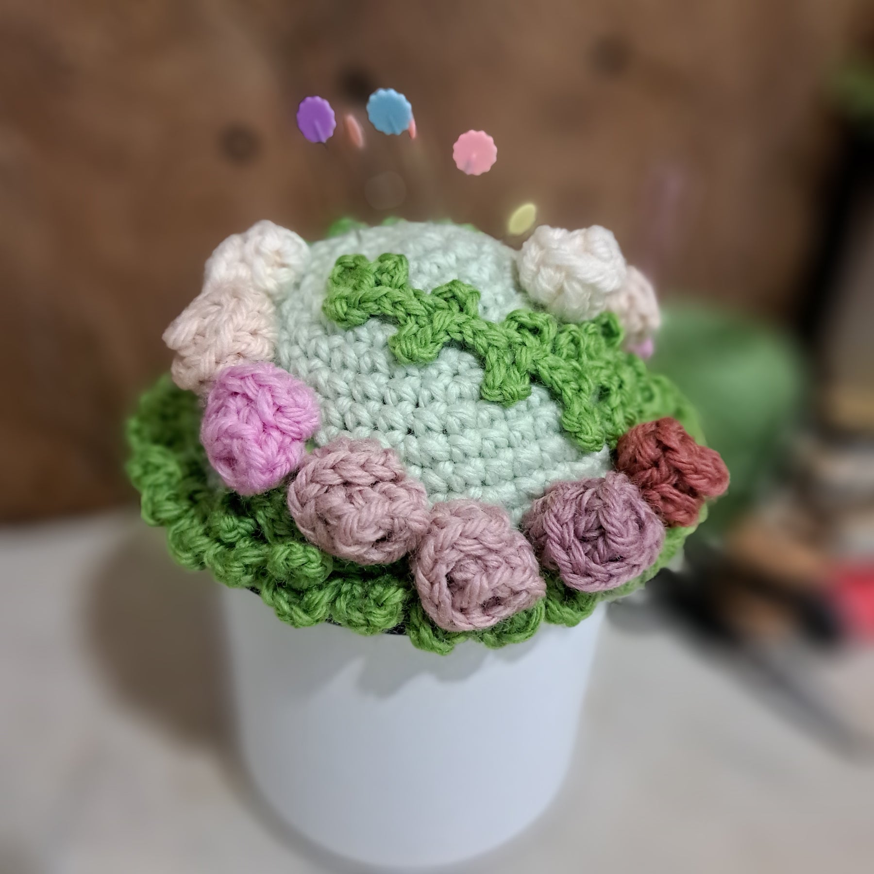 Crochet pin cushion with pretty roses in a sturdy enamel tin mug